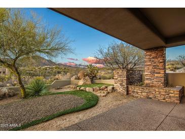 Landscaped backyard oasis with desert plants and mountain views at 10962 E Old Trails Rd, Scottsdale, AZ 85262