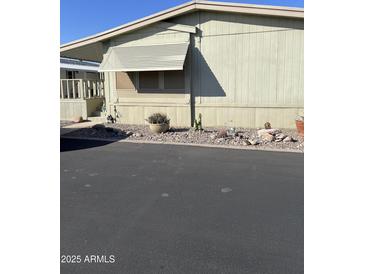 Mobile home exterior with landscaping and paved driveway at 11596 W Sierra Dawn Blvd # 105, Surprise, AZ 85378