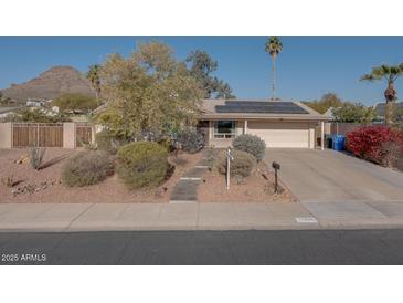 House exterior with a landscaped yard and solar panels at 14840 N 21St St, Phoenix, AZ 85022