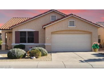 Charming single-story home with a two-car garage, low-maintenance landscaping, and a tile roof at 17449 N Fairway Dr, Surprise, AZ 85374