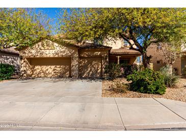 Inviting home featuring a three car garage and mature shade trees in a well kept front yard at 19308 W Jefferson St, Buckeye, AZ 85326