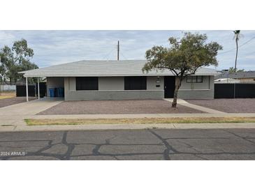 Single story home with gray exterior and gravel driveway at 2611 N 40Th Ave, Phoenix, AZ 85009