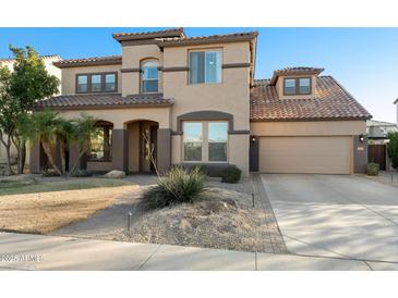 Charming two-story home featuring a tile roof, desert landscaping, and a two-car garage at 3115 E Turnberry Dr, Gilbert, AZ 85298