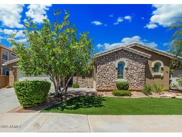 Craftsman style home with stone accents and a manicured lawn at 3374 E Virgil Dr, Gilbert, AZ 85298