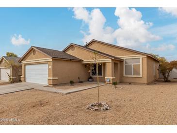 Single story home with a white garage door and desert landscaping at 3640 W Melinda Ln, Glendale, AZ 85308