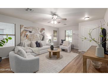 Bright living room with comfy seating and large artwork at 3645 E Sheffield Rd, Gilbert, AZ 85296