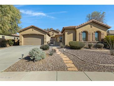 Charming home with a well-manicured, low-maintenance front yard and a stone walkway at 40325 N Graham Way, Anthem, AZ 85086