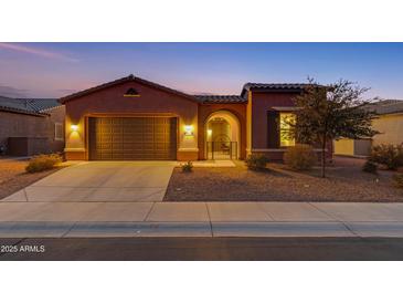 Attractive single-story home with a two-car garage and landscaped front yard at 41929 W Springtime Rd, Maricopa, AZ 85138