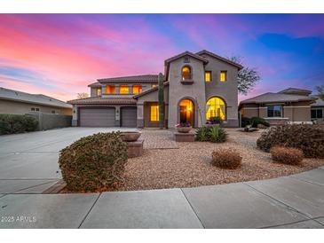 Two-story house with stucco exterior, three-car garage, and landscaped front yard at 44020 N 50Th Ln, New River, AZ 85087