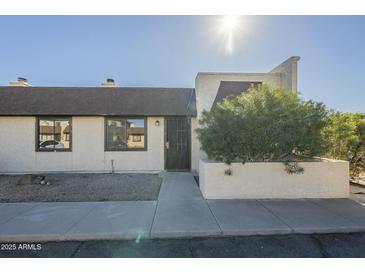 Cute condo exterior with well-maintained landscaping and a private entrance at 5115 N 22Nd Ave # 1, Phoenix, AZ 85015