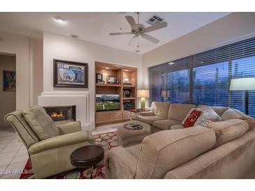 Cozy living room featuring a fireplace and comfortable seating at 7073 E Brilliant Sky Dr, Scottsdale, AZ 85266