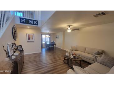 Spacious living room with hardwood floors and neutral colored couch at 736 E Ivanhoe St, Chandler, AZ 85225