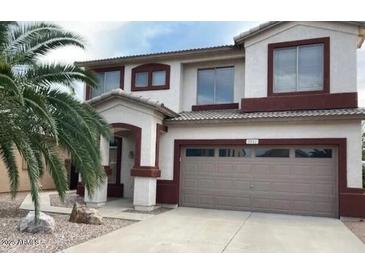 Two-story house with a large garage and desert landscaping at 9841 E Forge Ave, Mesa, AZ 85208