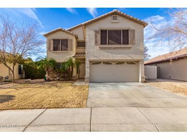 Charming two-story home featuring a large two car garage and desert landscaping at 11163 W Edgemont Ave, Avondale, AZ 85392