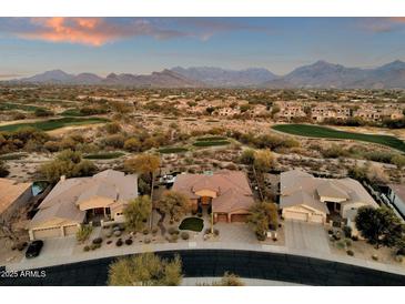 Aerial view of a house in a beautiful golf course community with mountain views at 19771 N 84Th Way, Scottsdale, AZ 85255