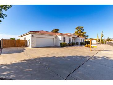 Single-story home with a two-car garage and a gated entrance at 2714 N 63Rd St, Mesa, AZ 85215