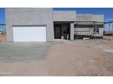Contemporary home exterior with a two-car garage and modern design elements under construction at 28551 N 257Th Ave, Wittmann, AZ 85361