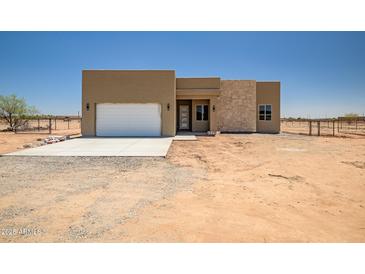 Contemporary single-story home featuring a neutral palette and eye-catching stone accents at 28615 N 257Th Dr, Wittmann, AZ 85361