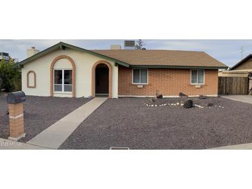 Brick ranch house with a landscaped front yard and walkway at 3506 W Yucca St, Phoenix, AZ 85029