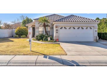 Single-story home with a two-car garage and well-manicured lawn at 7589 W Claremont St, Glendale, AZ 85303