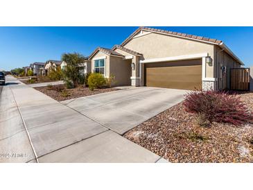 Attractive single-story home with a two-car garage and well-maintained landscaping at 8222 W Clemente Way, Florence, AZ 85132