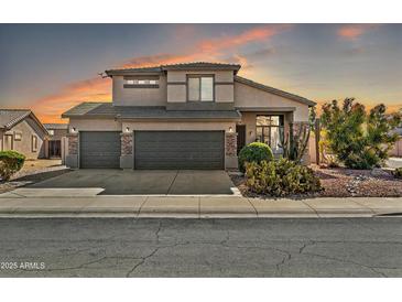 Two-story house with a three-car garage and desert landscaping at 15791 W Mohave St, Goodyear, AZ 85338