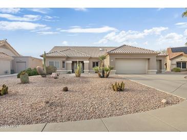 Single-story home with desert landscaping and a two-car garage at 22915 N Wagon Wheel Dr, Sun City West, AZ 85375