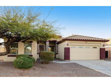 Charming single-story home with a two-car garage, mature tree, and desert landscaping at 2471 E Jade Dr, Chandler, AZ 85286