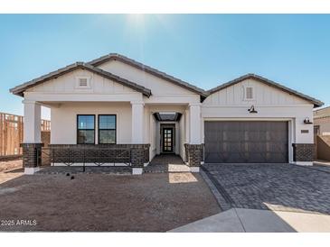 Stunning ranch-style home with a modern gray-toned garage door and brick accents at 2553 E Virginia Cir, Mesa, AZ 85213