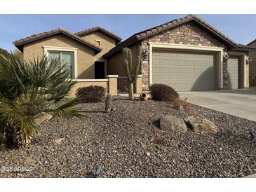 One-story home with stone and stucco exterior, two-car garage, and desert landscaping at 26496 W Burnett Rd, Buckeye, AZ 85396