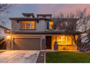 Two-story house with brown garage door, landscaping, and a spacious front yard at 29405 W Columbus Ave, Buckeye, AZ 85396