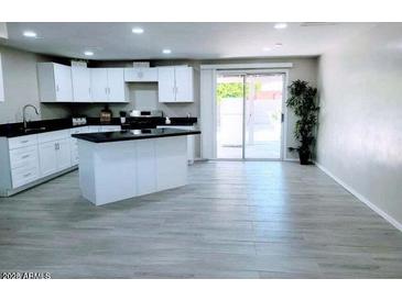 Modern kitchen with island and stainless steel appliances at 7150 W Montecito Ave, Phoenix, AZ 85033