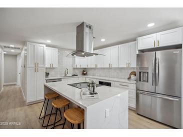 Modern kitchen features white cabinets, marble countertops, and stainless steel appliances at 7343 E Villa Way, Scottsdale, AZ 85257