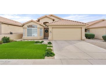 Beautiful desert home with artificial turf lawn and two-car garage at 7365 E Adele Ct, Scottsdale, AZ 85255