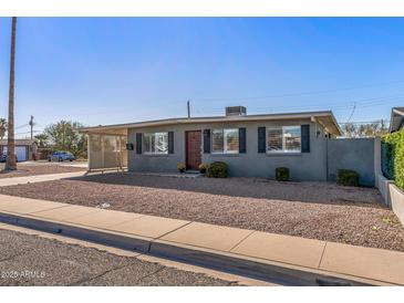 Charming single-story home with a covered carport, neat landscaping, and a welcoming front entrance at 7743 E Roosevelt St, Scottsdale, AZ 85257