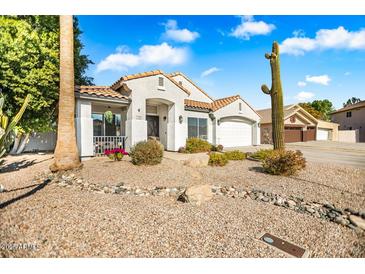 Single-story home with desert landscaping and a two-car garage at 7908 W Rose Garden Ln, Peoria, AZ 85382