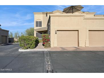 Tan two-story home with two-car garage and landscaped walkway at 11022 N Indigo Dr # 121, Fountain Hills, AZ 85268