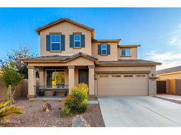 Two-story house with neutral exterior, landscaped yard, and attached garage at 1625 W Cool Water Way, San Tan Valley, AZ 85144