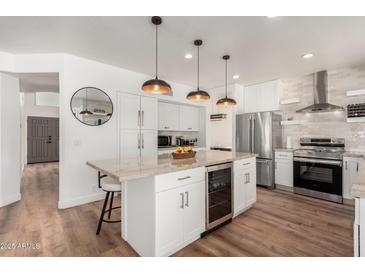 Modern kitchen with granite island and stainless steel appliances at 16414 N 48Th Way, Scottsdale, AZ 85254