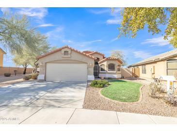 Single-story home with a two-car garage and well-manicured lawn at 20902 N 36Th Pl, Phoenix, AZ 85050