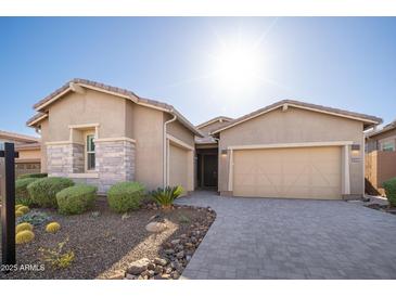 Inviting single-Gathering home featuring a three-car garage and desert landscaping at 23448 N 76Th Pl, Scottsdale, AZ 85255