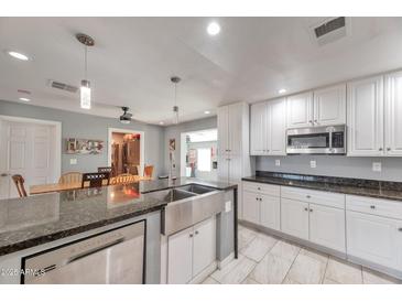 Spacious kitchen with stainless steel appliances and granite countertops at 2641 W Wethersfield Rd, Phoenix, AZ 85029