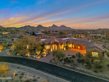 Luxury home with scenic mountain views at sunset, featuring a large backyard and pool at 29600 N 106Th N Pl, Scottsdale, AZ 85262