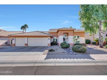 Single-story home with two-car garage and landscaped front yard at 3439 E Topeka Dr, Phoenix, AZ 85050