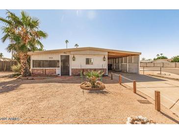 Ranch-style home with carport and desert landscaping at 355 S 58Th St, Mesa, AZ 85206