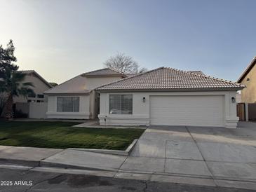 White single-story house with a two-car garage and well-maintained lawn at 3743 W Shannon St, Chandler, AZ 85226