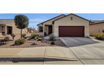 Single-story home with desert landscaping and a two-car garage at 42157 W Cribbage Rd, Maricopa, AZ 85138