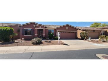 Charming single-story home with a two-car garage and desert landscaping at 42621 W Heavenly Pl, Maricopa, AZ 85138