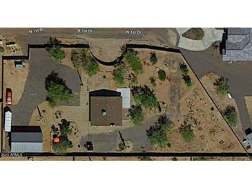 Aerial view showing a house with a large backyard and surrounding desert landscape at 44311 N 1St Dr, New River, AZ 85087