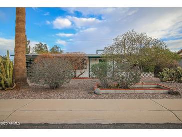 Ranch style home with landscaped front yard and driveway at 5720 E Cicero St, Mesa, AZ 85205